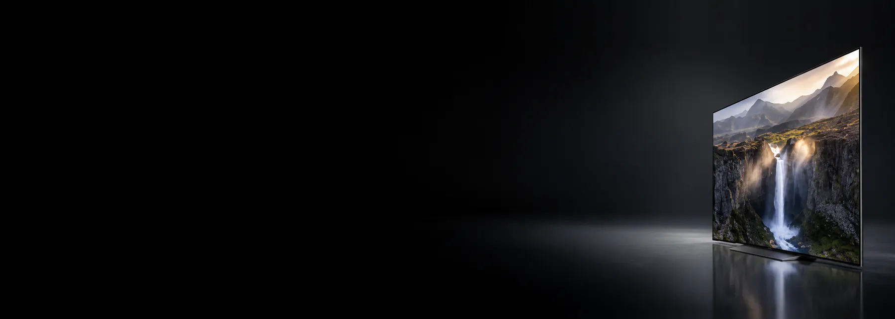 An LG OLED television in a dark room, angled to the camera